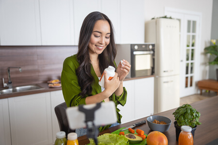 Woman holding supplement bottle