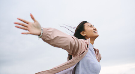 Woman with arms raised in the air