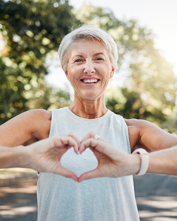woman making heart shape with hands