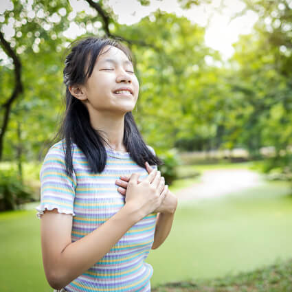 woman with hands over her heart