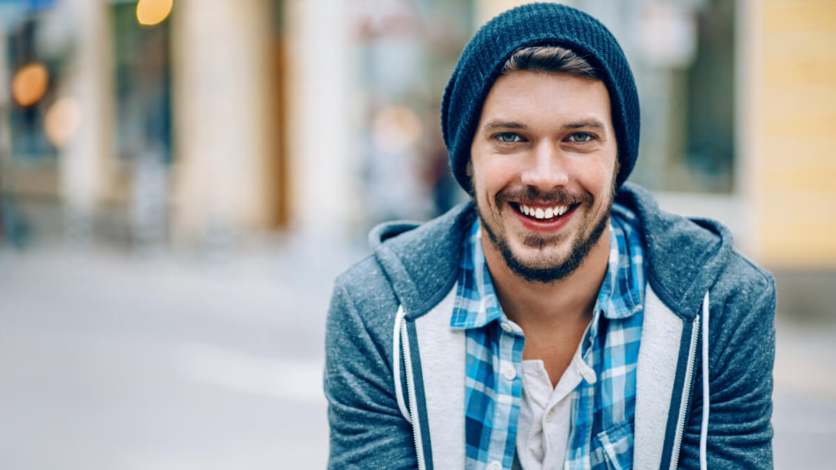 smiling young man in beany