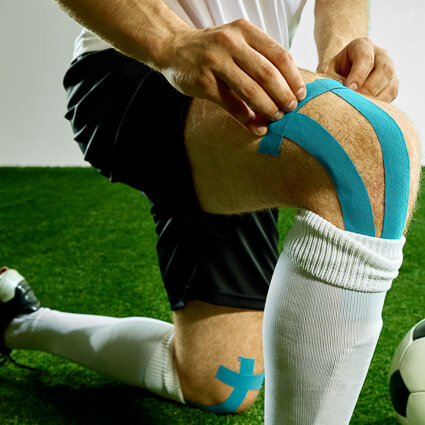Soccer player with kinesiotape on knee
