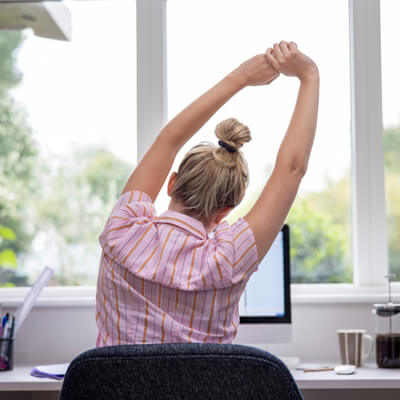 Woman stretching at desk