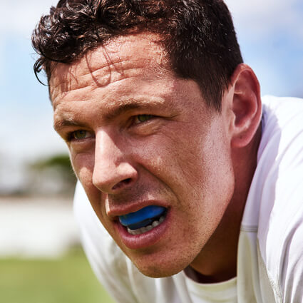 man with blue mouthguard