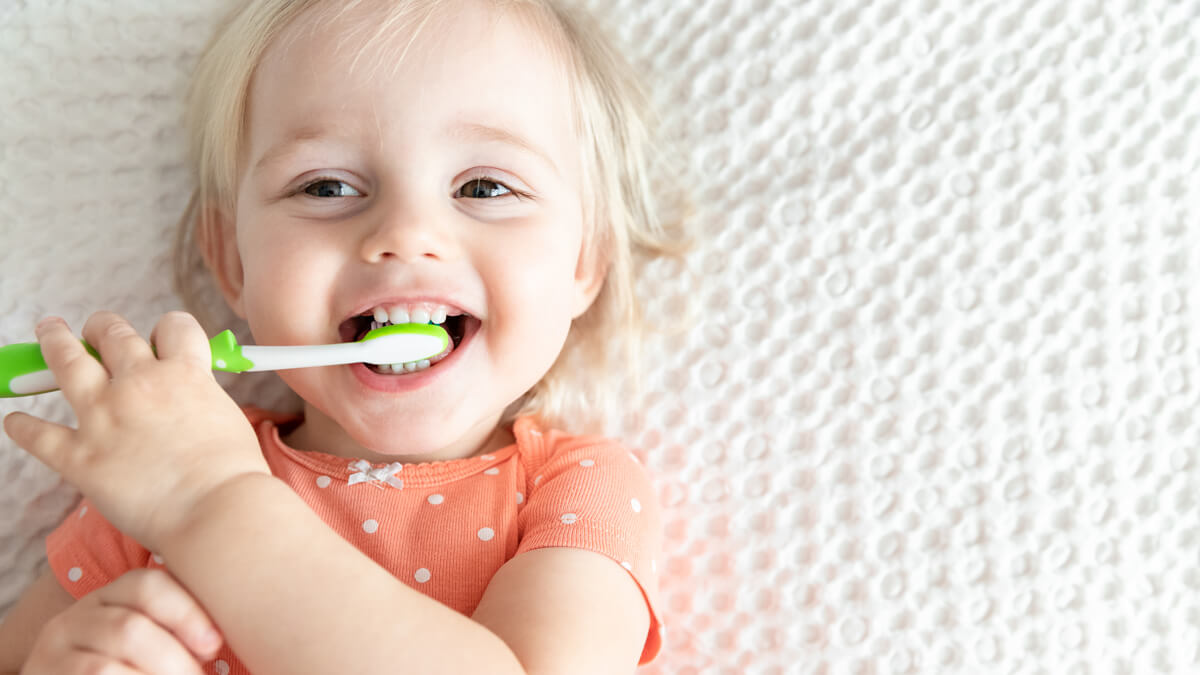 Toddler with toothbrush in mouth