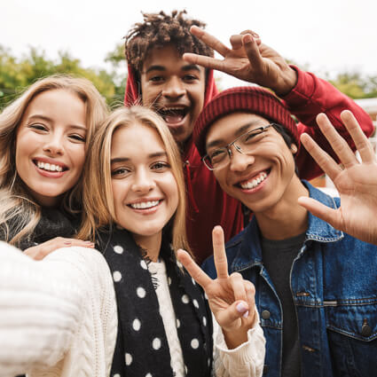 teen boys and girls taking selfie together