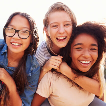 teenage girls smiling together