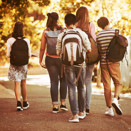 Teens walking wearing backpacks