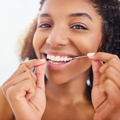 Woman flossing teeth