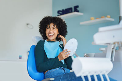 Smiling lady sitting on dentist chair