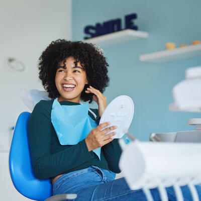 woman smiling in dentists chair