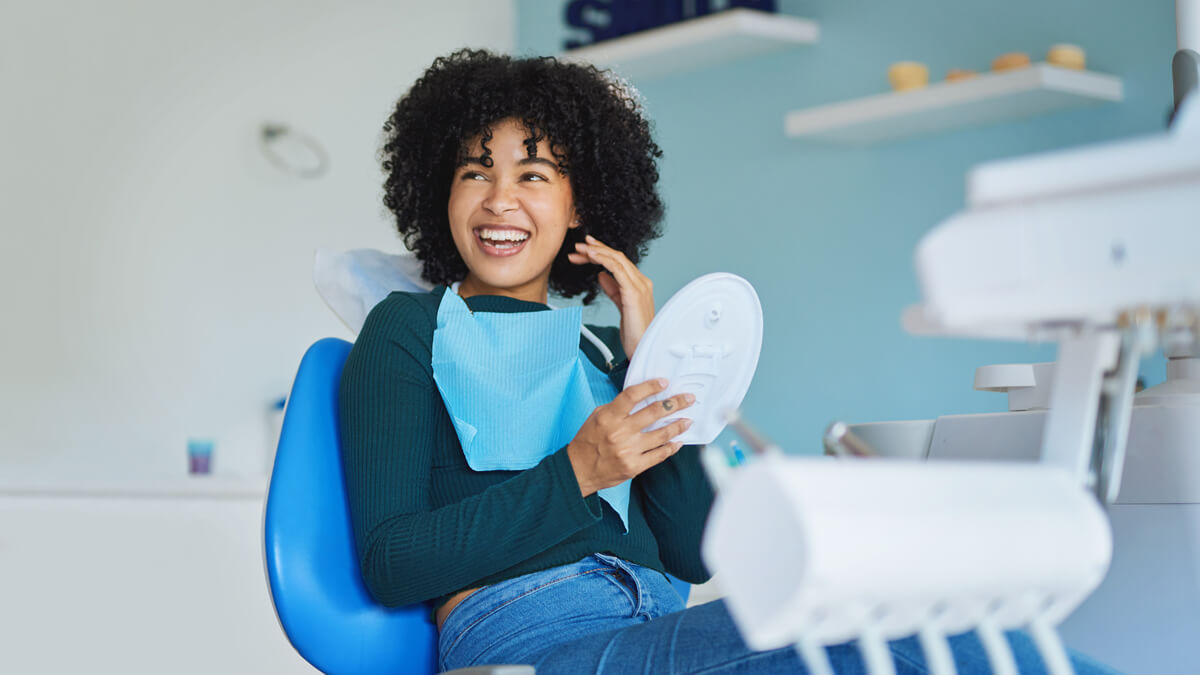 Woman smiling happliy and thankfully at the dentist