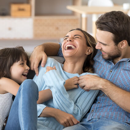 Smiling family of three