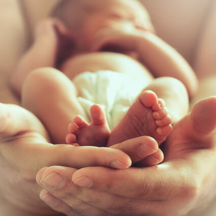 Holding newborn baby