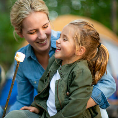 Mom and daughter toasting marshmellows