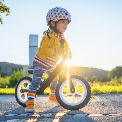 Child on riding bike outside