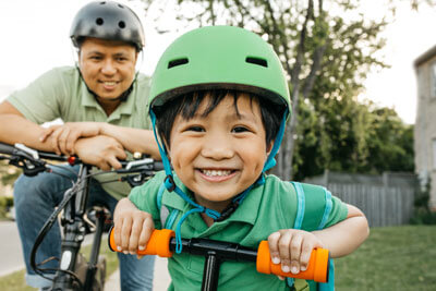 toddler riding bike with dad