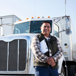 Truck driver standing by semi truck