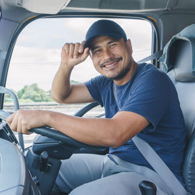 truck driver smiling and tipping his hat