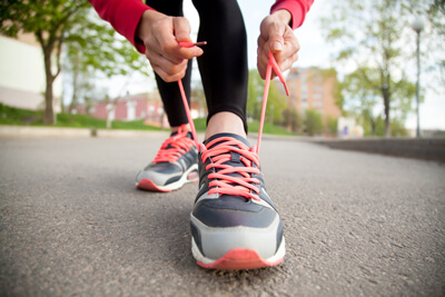 Woman tying her shoe