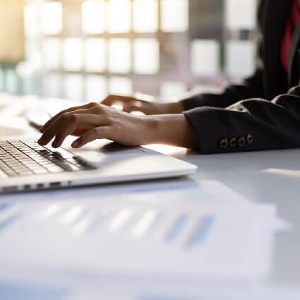 person typing on their computer