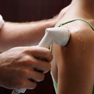 Female patient getting ultrasound therapy on shoulder