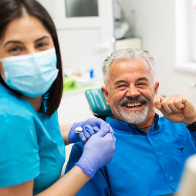 very happy man at dentist