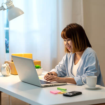 smiling person looking at computer