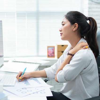 woman working at desk slumped over