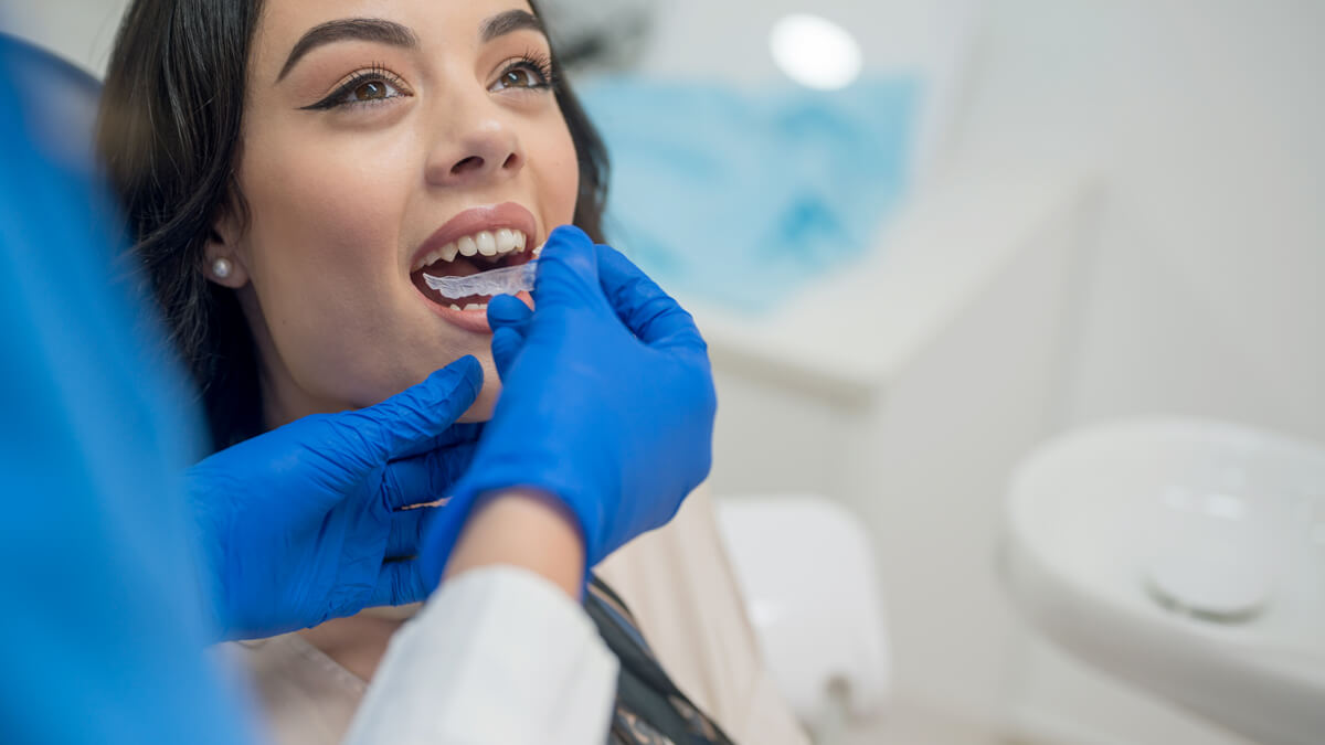 woman being fitted with clear aligners