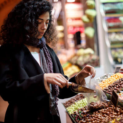 Woman filling bulk bags at the grocery store