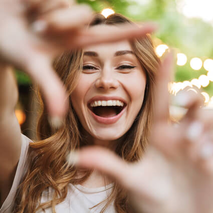 Woman framing face with hands