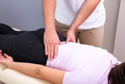 woman getting low back adjusted