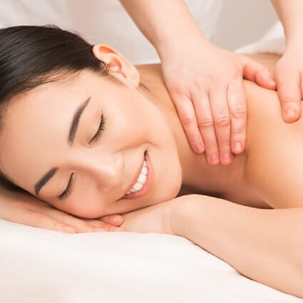 Smiling female patient receiving a massage