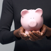 Woman holding pink piggy bank