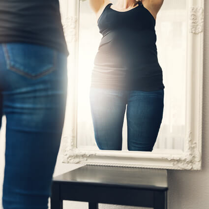 Woman standing in front of a mirror