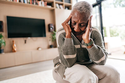 woman in bright room with headache