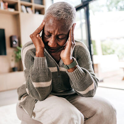 Woman holding her head in pain