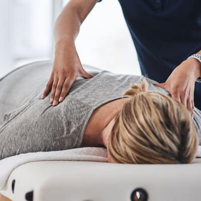 Woman in grey shirt getting massage