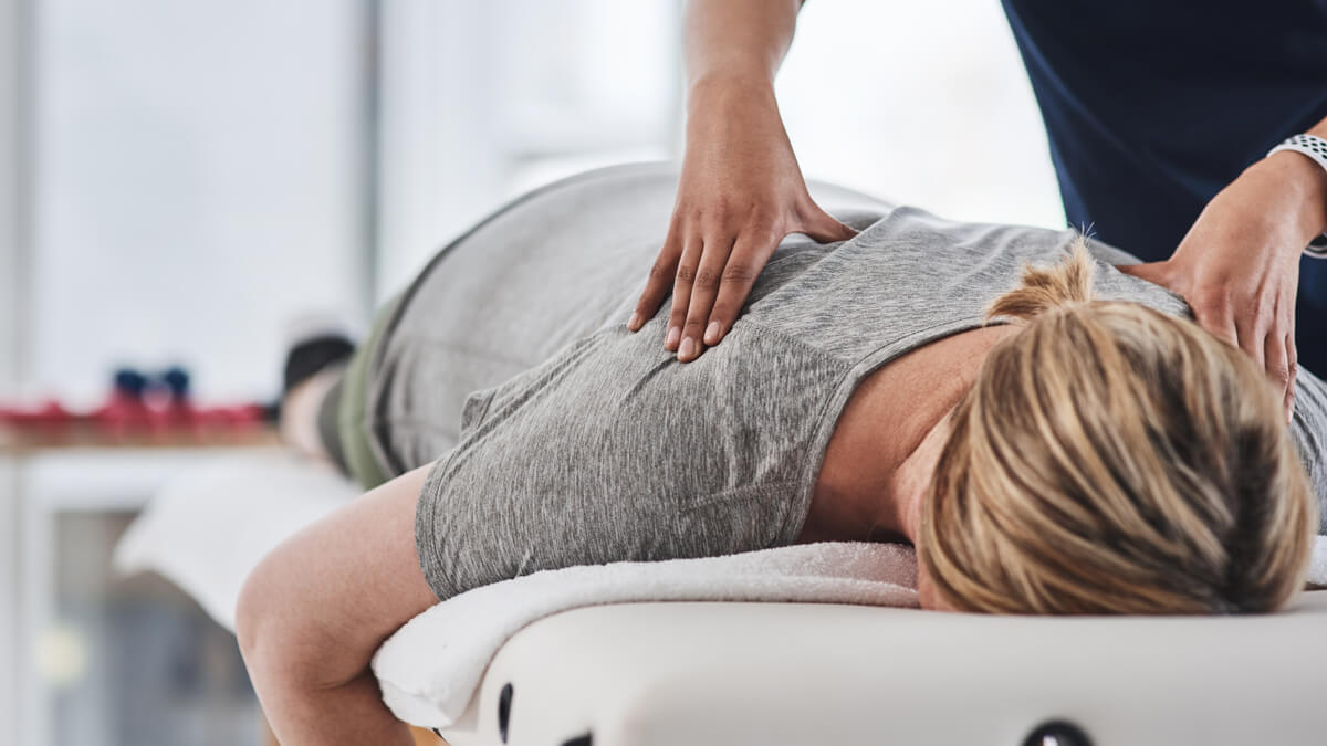 Woman in grey t-shirt massaged