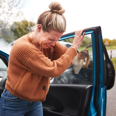 Woman holding neck after accident