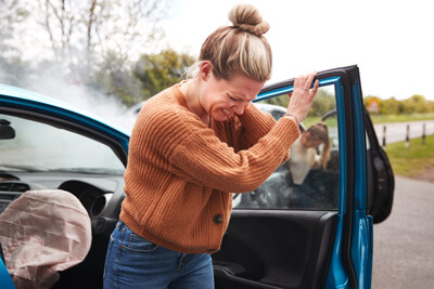 Woman holding her neck after accident