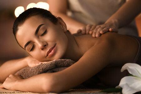 Woman laying down getting a relaxing back massage
