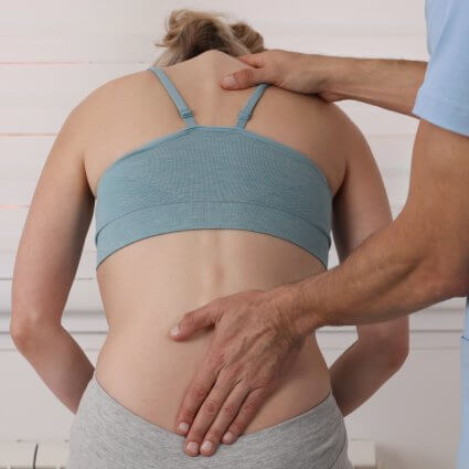 Woman leaning forward for spinal decompression exam