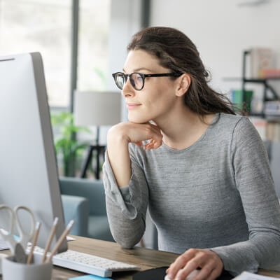 Woman leaning into computer screen