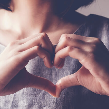 Woman making heart hands