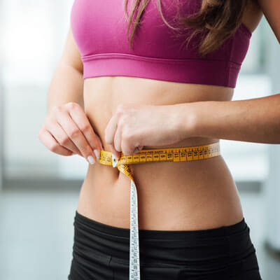 Woman measuring her stomach