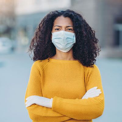 woman outside with mask and gloves