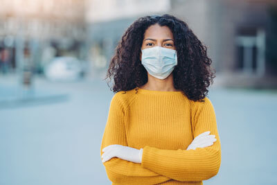 woman outside with mask and gloves