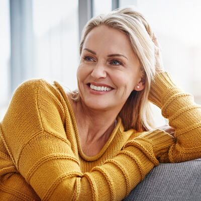 Woman relaxing on couch with a smile